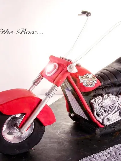 A red Harley Davidson cake, posted to celebrate the color red during Navratri, symbolizing strength and power.