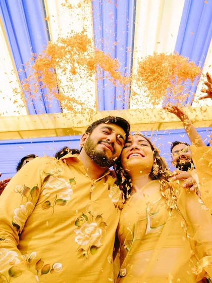 The couple looking up, blissfully happy, as a rain of petals falls on them. A perfectly captured memory.