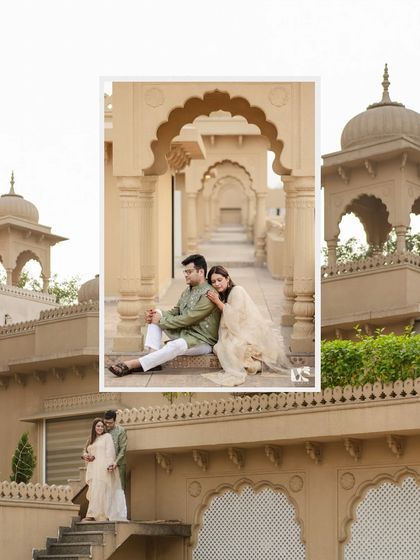A creative, layered photo from a couple's shoot at a palace-like venue. This composition beautifully frames their quiet, intimate moment within the grand architecture.