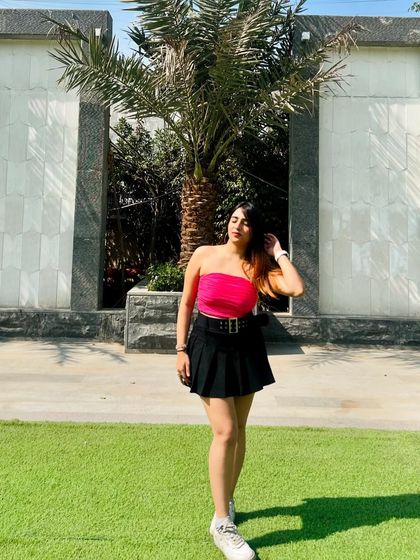 A final pose in the pink top and black skirt. This is a perfect example of a fun, summery, casual outfit.