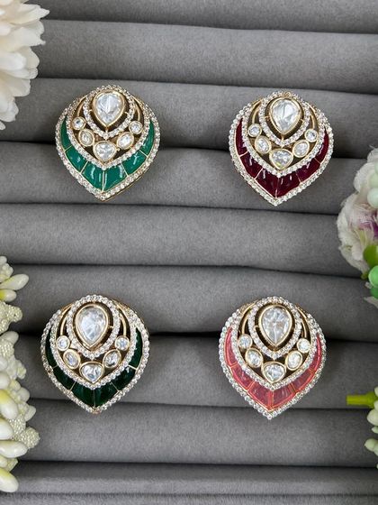 Our leaf-shaped adjustable rings, featuring a large central Moissanite stone surrounded by American Diamonds. These are available in green, red, and pink Meenakari finishes.