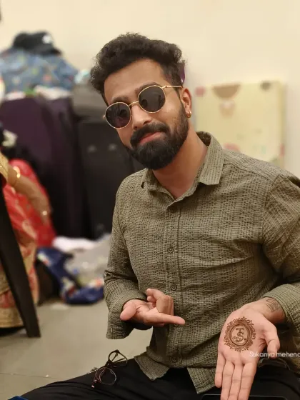 Mehendi isn't just for brides. I create stylish and simple designs for grooms too, like this personalized initial in a mandala, so they can be a part of the tradition in their own way.