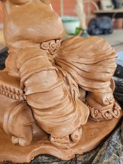 A close-up of the intricate folds and textures on the base of a Ganesha sculpture. This is where patience and skill come together.