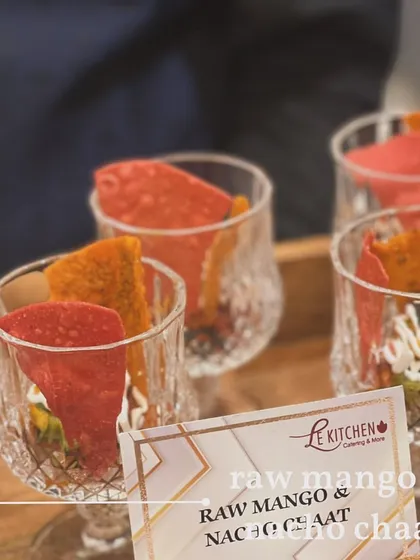 A playful fusion of Mexican and Indian street food. This is a Raw Mango and Nacho Chaat, combining the tang of raw mango with the crunch of nachos in a layered glass.