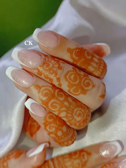 A close-up of the glittery French manicure, showing the subtle shimmer that adds a special touch to this classic bridal style.