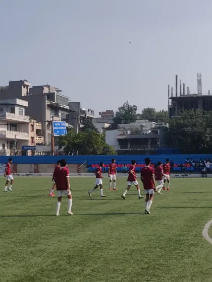 The team spread out across the pitch during a pre-match warm-up, focused and preparing for the game ahead.