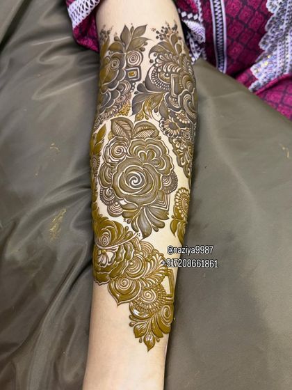 A close-up of a fresh rose-themed design on the arm.