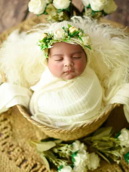 This shot includes a delicate floral crown, adding an extra touch of elegance to the all-cream setup.