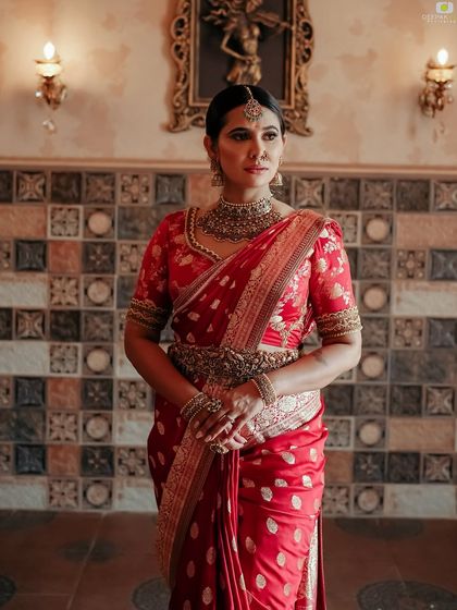 A full-length shot of me in the red saree, showing the beautiful drape and the overall regal look of the outfit.