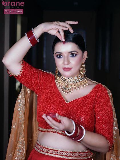 This pose highlights the traditional elements of the reception look, such as the bindi. I teach my students to be versatile in both modern and traditional styles.