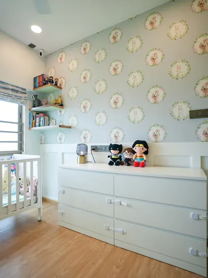A wider view of the nursery wall, showcasing the board and batten detailing on the lower half and the playful wallpaper above.