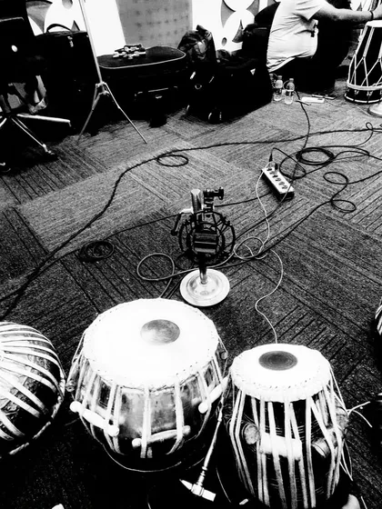 A black and white shot of the studio floor, showing the tools of my trade. Multiple tablas and microphones are set up, ready for a session to bring a composer's vision to life.