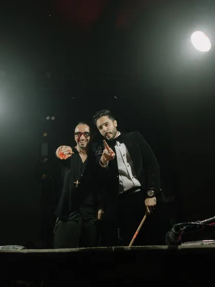 The afterparty vibe of the Met Gala wedding. This photo captures the dark, glamorous, and high-energy mood with the groom and his friends on stage.