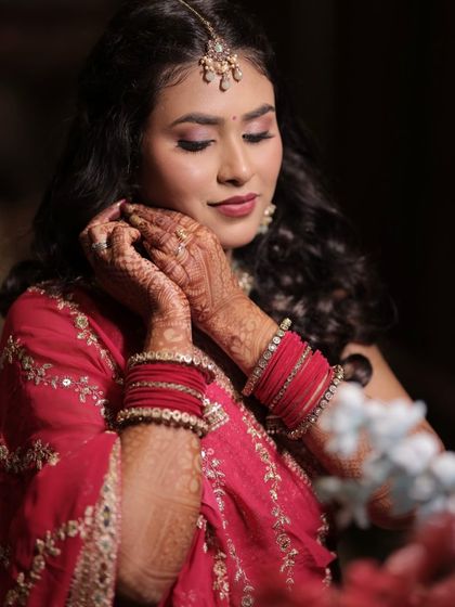 A close-up of the sangeet look. We created a soft, shimmery eye with a beautiful pink lip color that perfectly matches the tones in her outfit.