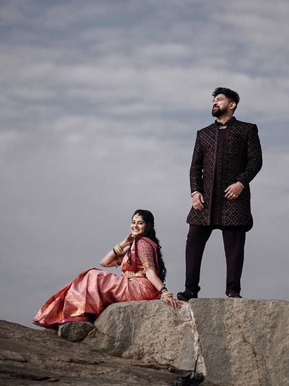 A majestic portrait of the couple on a rock, set against the sky. This low angle shot makes them look powerful and heroic.
