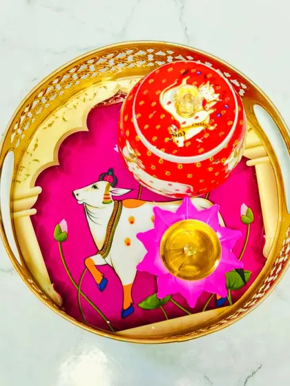 Here is another beautiful Pichwai-themed tray set, this time with a vibrant pink background. It's a perfect base for arranging sweets, diyas, and other festive items.
