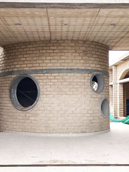 The cylindrical activity room at the heart of Sai Kirupa Special School. The circular windows at different heights offer playful glimpses in and out, creating a unique and engaging space for the students.