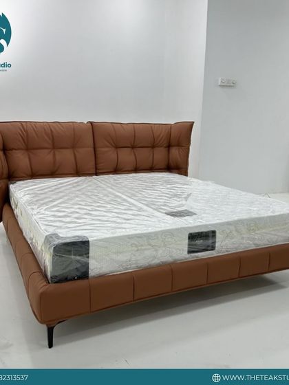 This modern bed in a rich tan leatherette makes a bold statement. The plush, oversized headboard is quilted for extra comfort and style, supported by a sleek, minimalist frame.
