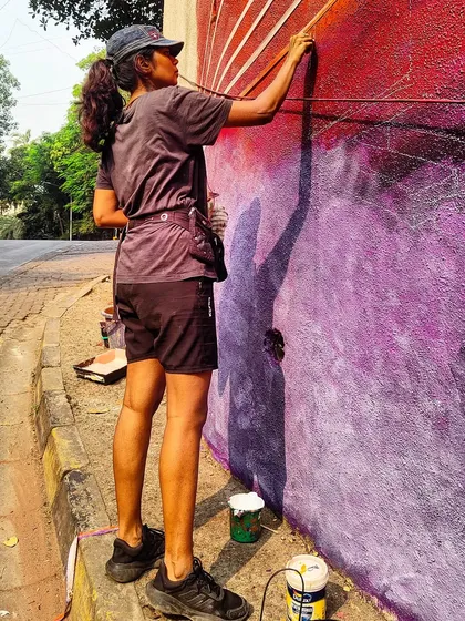 Here's the lead artist, Maad Eye, working on the vibrant colors of the Ed Sheeran mural. It was an honor to be on the team and assist in executing her vision for this large-scale project.