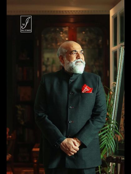 A close-up headshot from the same series, focusing on the subject's distinguished features and confident expression.