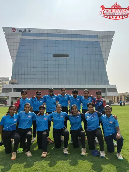 The team posing proudly in front of the Jio Institute building, a top-class facility for their tournament match.