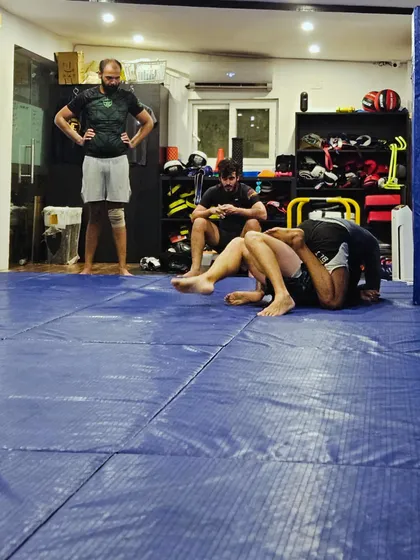 A coach observes a live roll, ready to offer feedback. Constant learning is part of our culture.