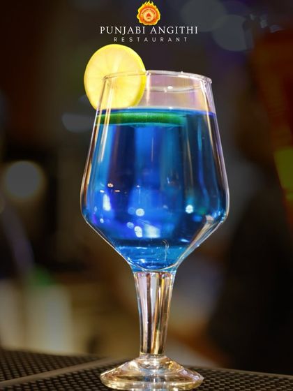This vibrant blue mocktail is one of my signature drinks. It's not just a drink, it's a whole mood, perfect for celebrating a six or calming down after a close call.