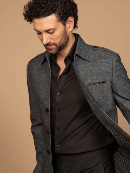 The grey shacket in motion, revealing the patterned lining. Even in casual pieces, I ensure every detail is considered.