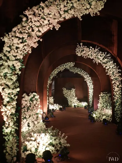 Another view of the floral arched tunnel, showcasing the depth and perspective we create with repeating structures. This design is perfect for a grand entrance to an evening cocktail or sangeet party.