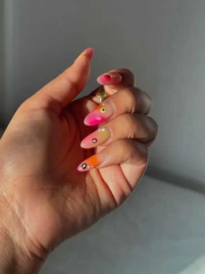 The glossy finish enhances the vibrant, hand-painted colors of this unique and artistic nail set.