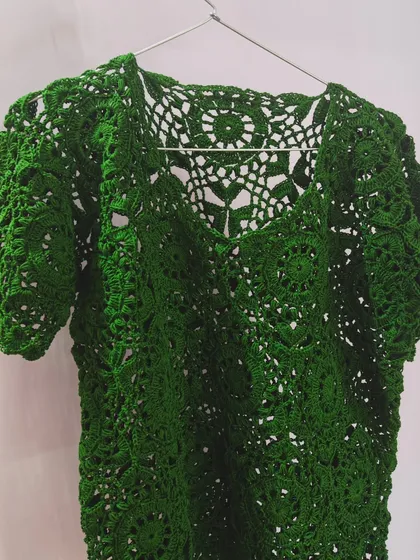 A clean shot of the green lace top, showcasing its structure and the beautiful V-neckline. It’s a design I am incredibly proud of.