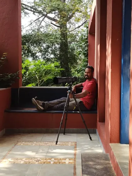 Even when I'm relaxing, I'm always ready. Here I am set up with my telephoto lens on the porch, hoping to capture any bird or wildlife that might appear.