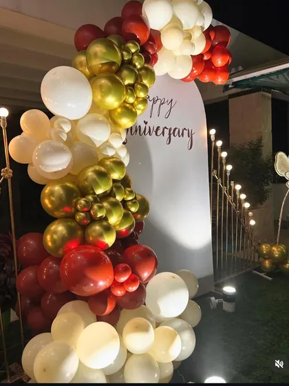 A close-up view of the balloon garland from the anniversary backdrop. This shows the combination of metallic and matte balloons used to create a rich, textured look for the celebration.