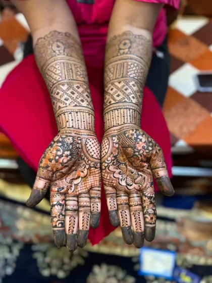 This engagement mehendi features heavy geometric patterns on the forearms, which is a very popular and modern choice. The palms have a mix of floral and traditional work.