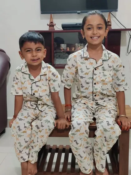 The smiles say it all. These two siblings are looking adorable in our block-printed Dino nightwear. It's a unisex design that’s a big hit with little explorers.