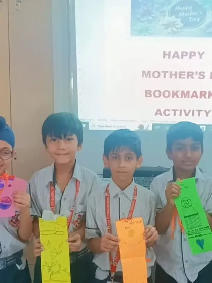 Students proudly display the bookmarks they created as gifts for Mother's Day, combining creativity with a love for reading.