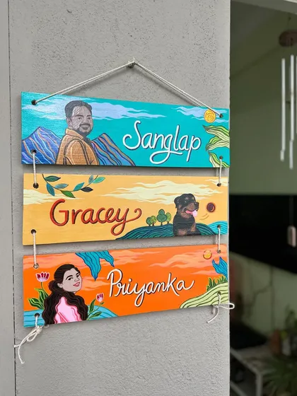 A unique, three-tier hanging nameplate I created for Priyanka's family. Each panel features a portrait of a family member, including their adorable fur baby, Gracey.