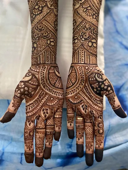 A beautiful and intricate design featuring large paisley and peacock motifs, perfect for a bride who loves classic patterns.