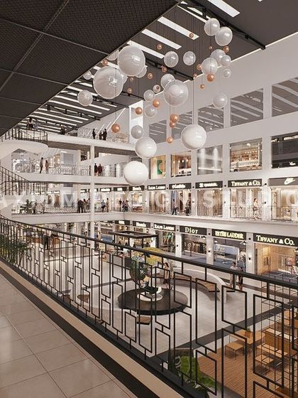 A view from an upper level, looking down into the atrium. The design uses spherical pendant lights to add a whimsical touch.