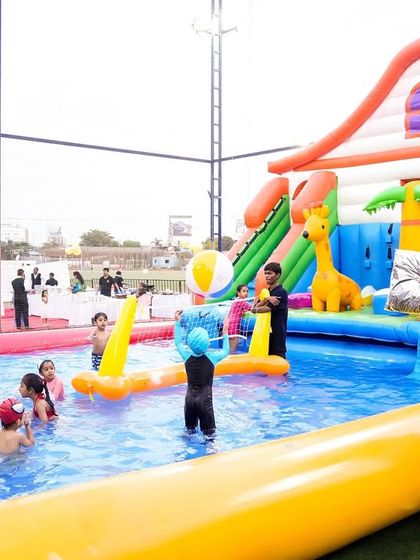 Another angle of the large inflatable slide, showing its impressive scale and the safe, enclosed pool area at the bottom.