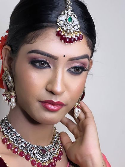 A close-up of a model wearing a beautiful Victorian-style set with ruby beads. The oxidized finish gives it a unique, antique charm.