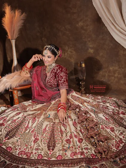 A full-length shot of a bride in a magnificent lehenga. We train artists to consider the entire look, ensuring the makeup complements the scale and detail of the bridal attire.