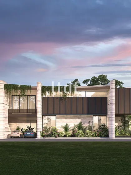 This contemporary residence embraces a minimalist aesthetic, where soft stone textures and cascading greenery create a tranquil facade. The design integrates nature into its very fabric, blurring the line between the built environment and the landscape.