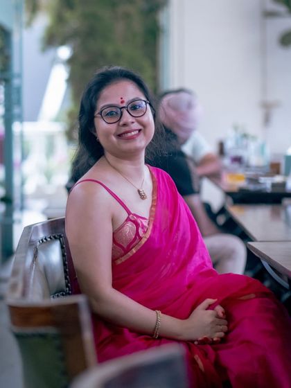 A guest in a beautiful pink saree, enjoying the elegant ambiance of our Golden Circle gathering.