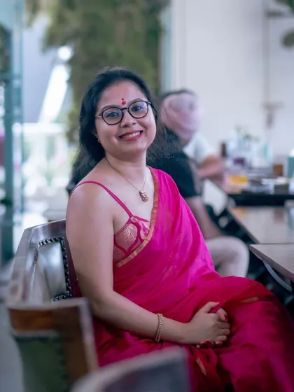 A guest in a beautiful pink saree, enjoying the elegant ambiance of our Golden Circle gathering.