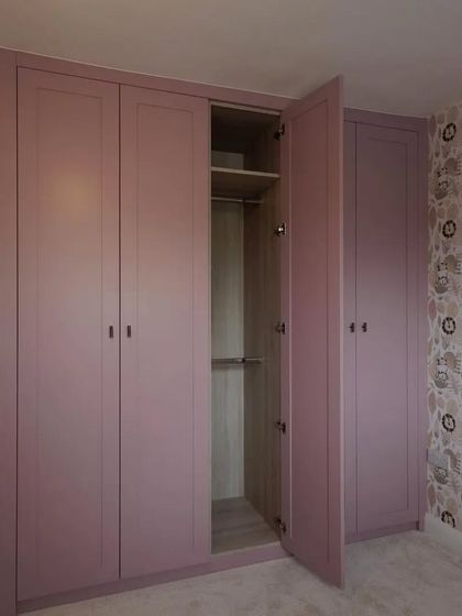We brought a client's vision to life with this charming baby pink wardrobe. The open door reveals a well-organized interior with hanging space and shelving, perfectly blending a playful aesthetic with practical functionality.