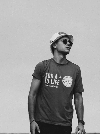 A candid black and white shot of me on the court. My motto is to "Add a + to life with volleyball."