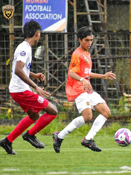An action shot capturing the speed and agility of our player as he evades a tackle in a league game.