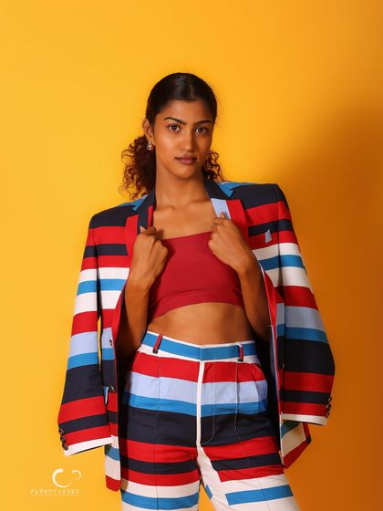 A classic half-body shot that showcases the suit's bold design. Her direct gaze is confident and captivating.