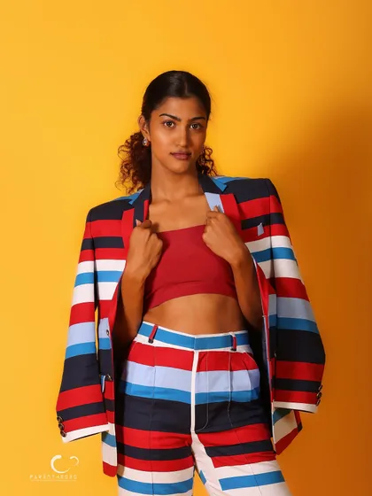 A classic half-body shot that showcases the suit's bold design. Her direct gaze is confident and captivating.